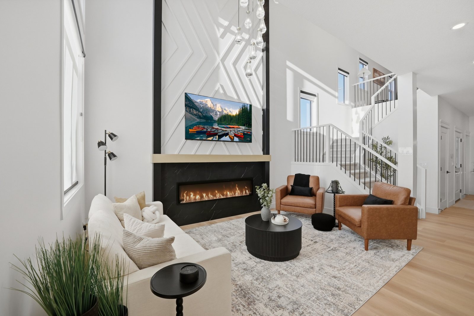 Great room with linear fireplace in the Aspen Living showhome at 200 Edgefield Bay, Strathmore