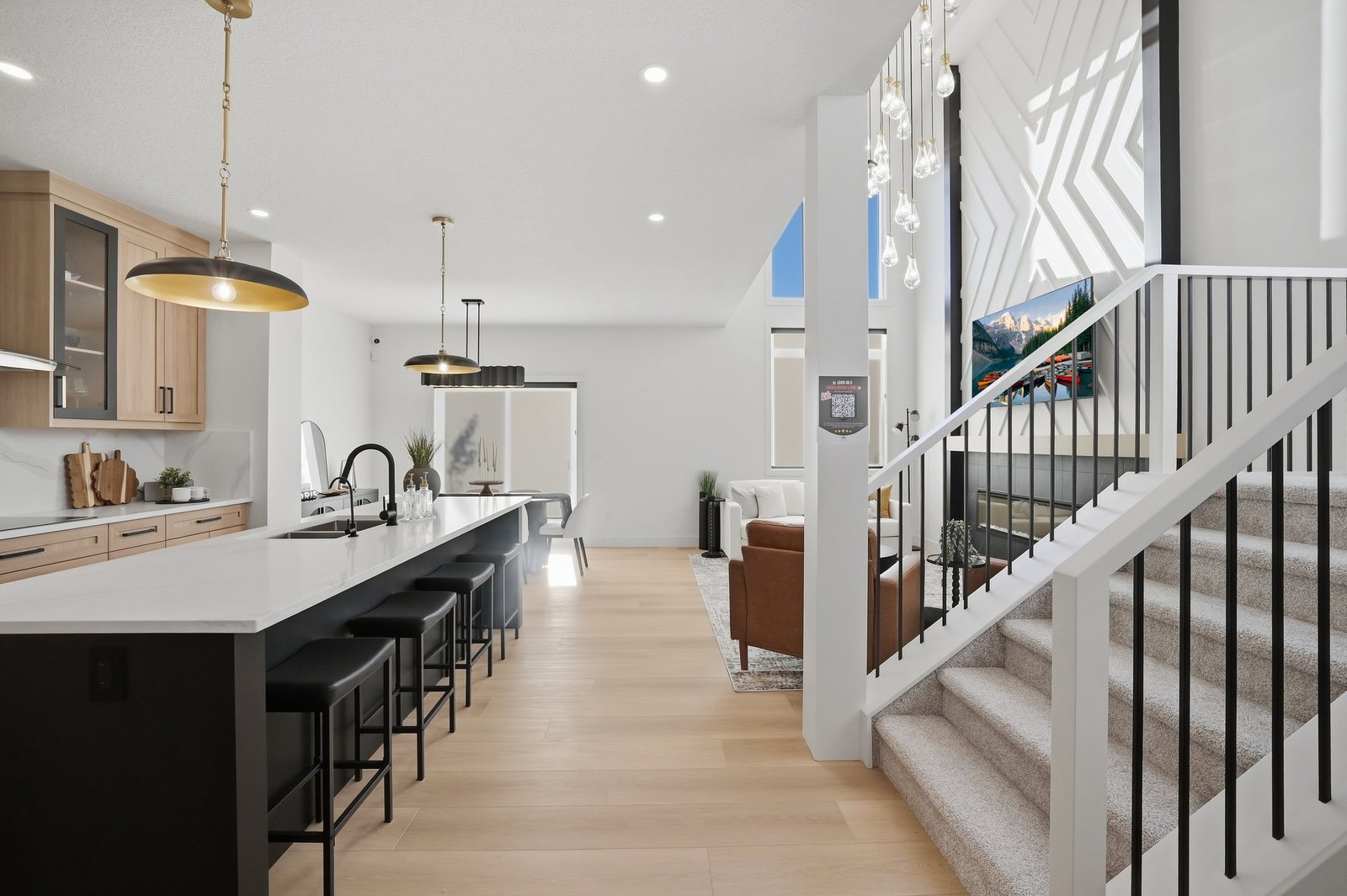 Kitchen island and open staircase in the Aspen Living showhome