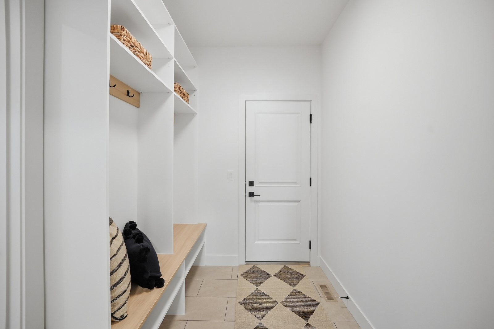 Mudroom with built-in bench and storage in the Aspen Living showhome, 200 Edgefield Bay