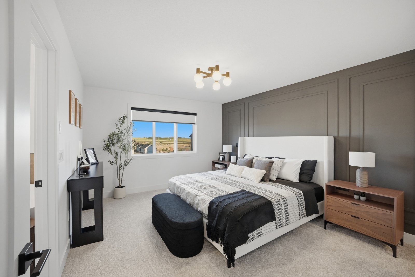 Primary bedroom with feature wall in the Aspen Living showhome, 200 Edgefield Bay