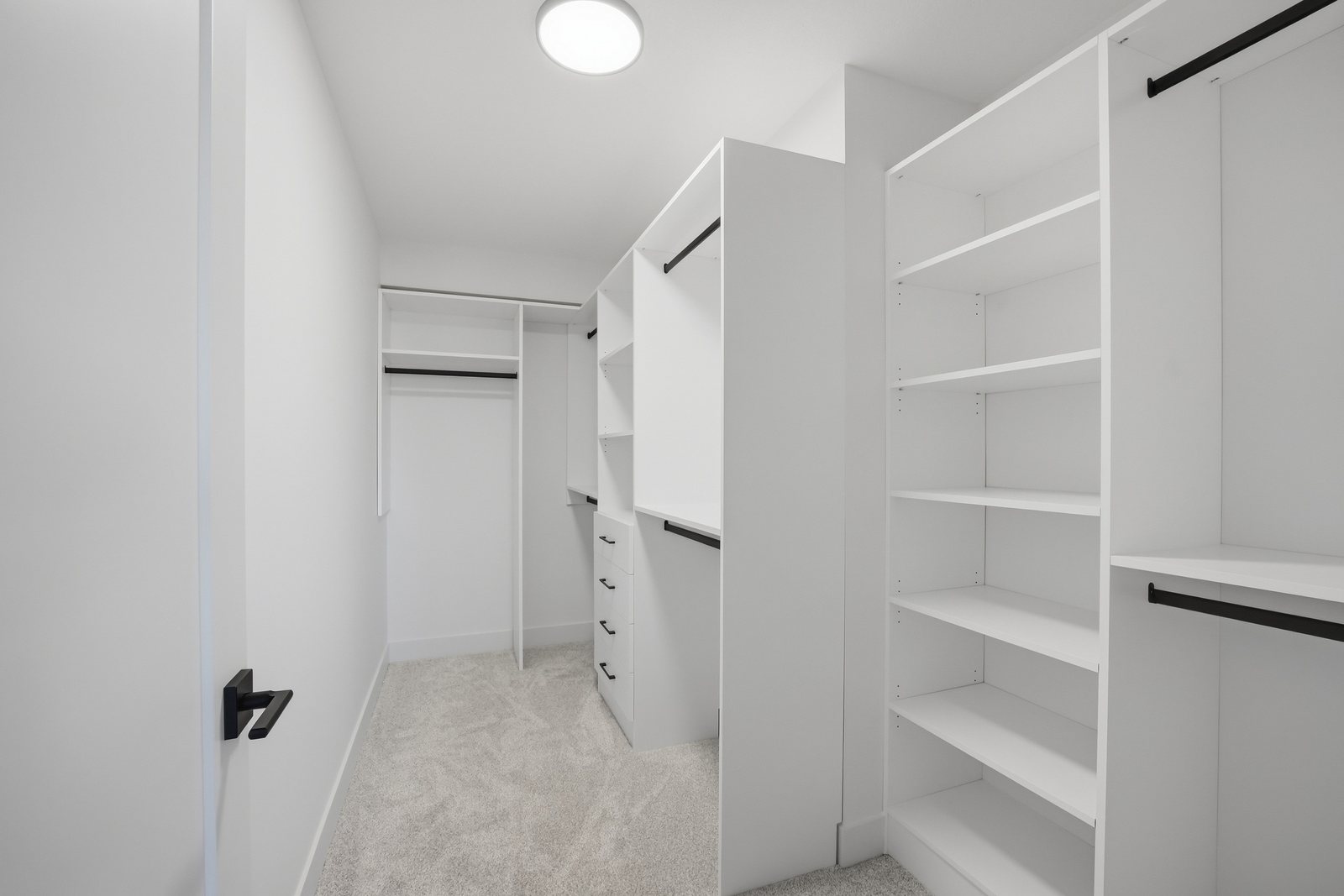 Primary walk-in closet in the Aspen Living showhome, 200 Edgefield Bay