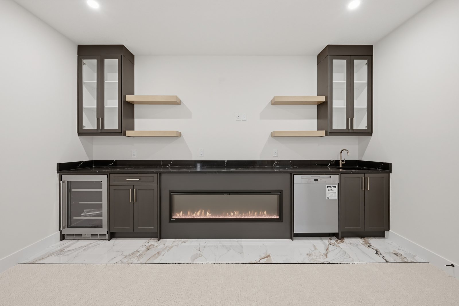 Basement wet bar with fireplace in a Waterford Estates home by Aspen Living