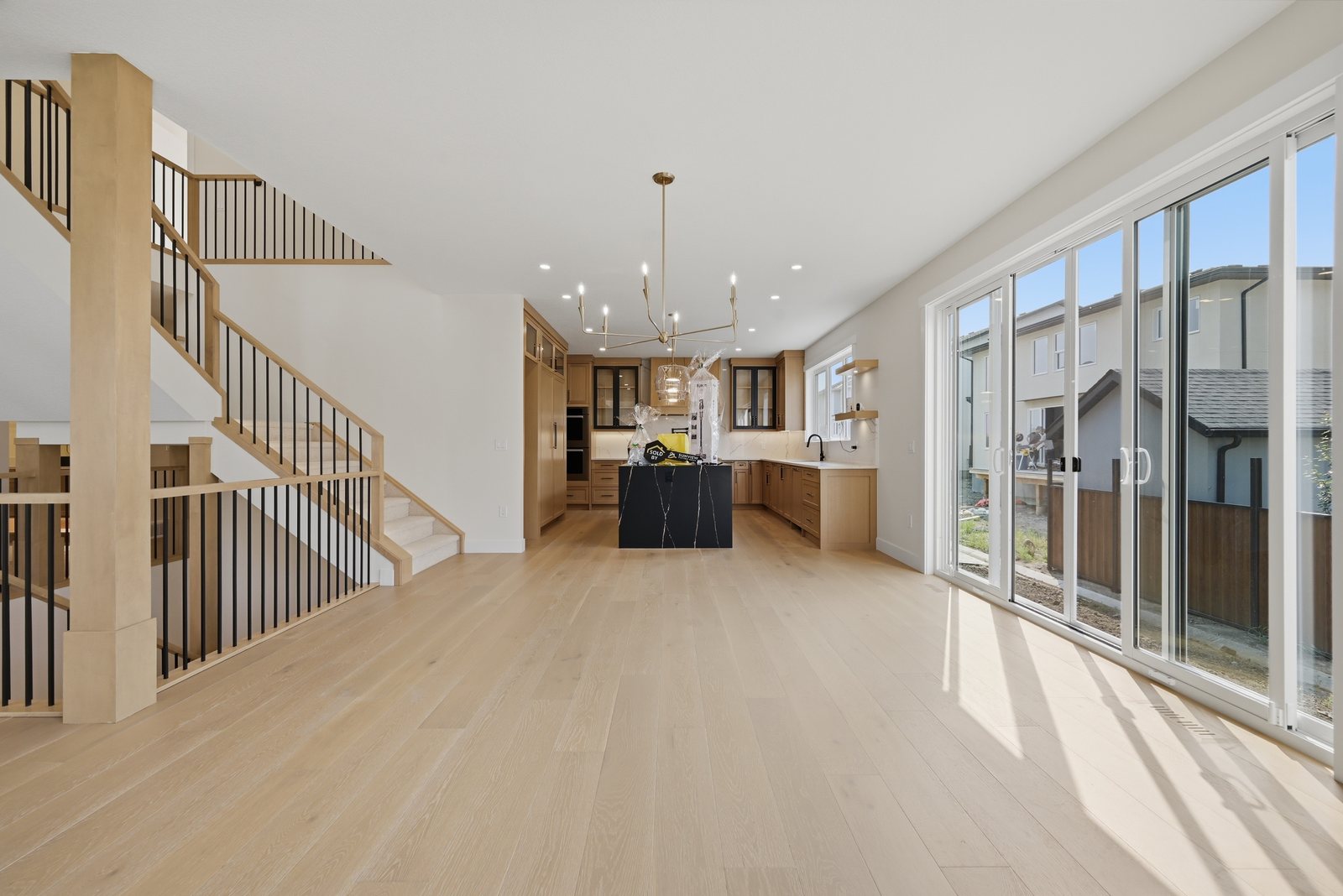 Open main floor with large windows in a Waterford Estates home by Aspen Living