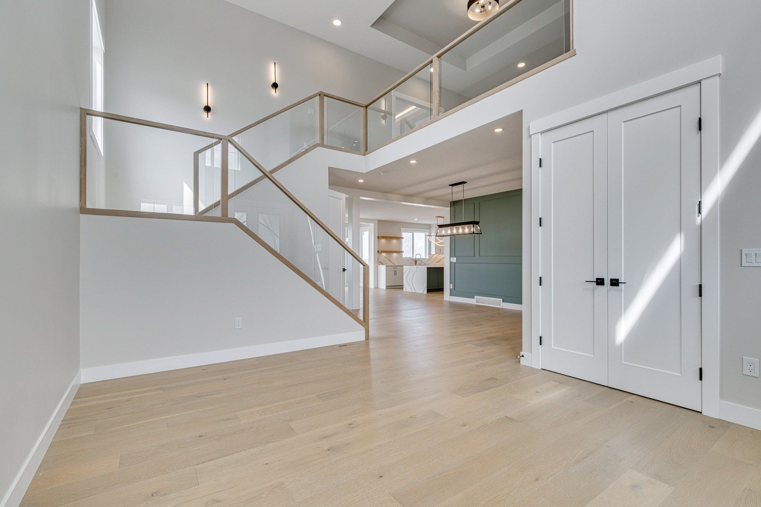 Open-to-above entry with a glass railing in a Waterford Estates home by Aspen Living