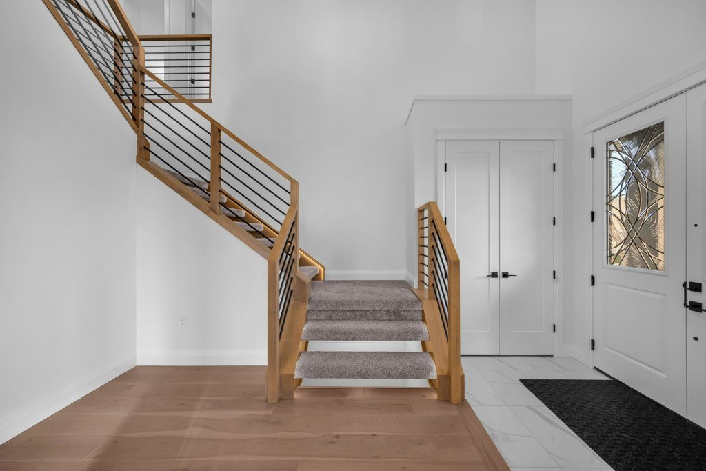 Open staircase with metal railing in a Waterford Estates home by Aspen Living